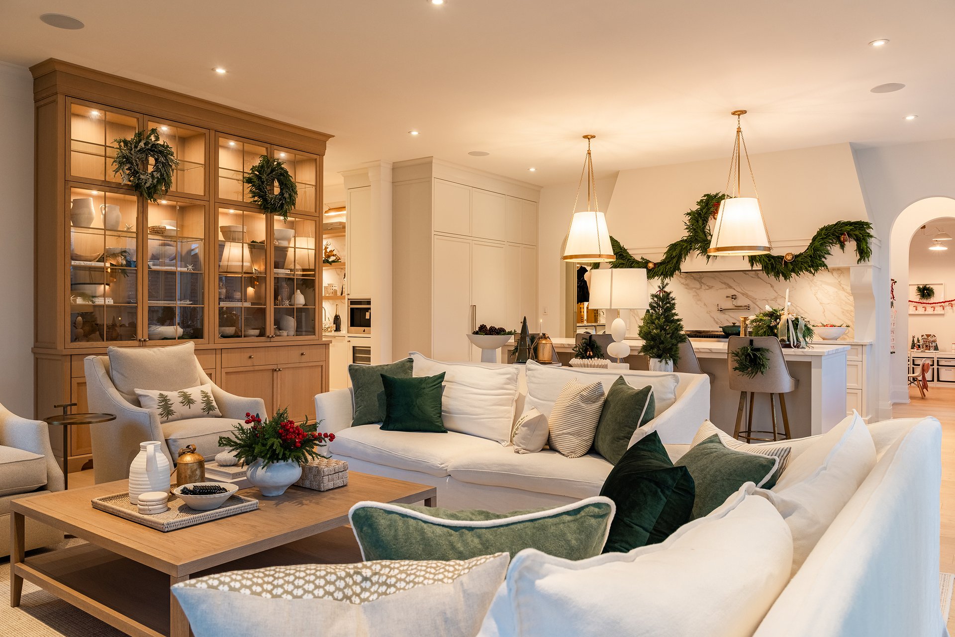 Bright breakfast nook in an Oakville custom home with floor-to-ceiling windows, a white round table, and a festive holiday floral arrangement.