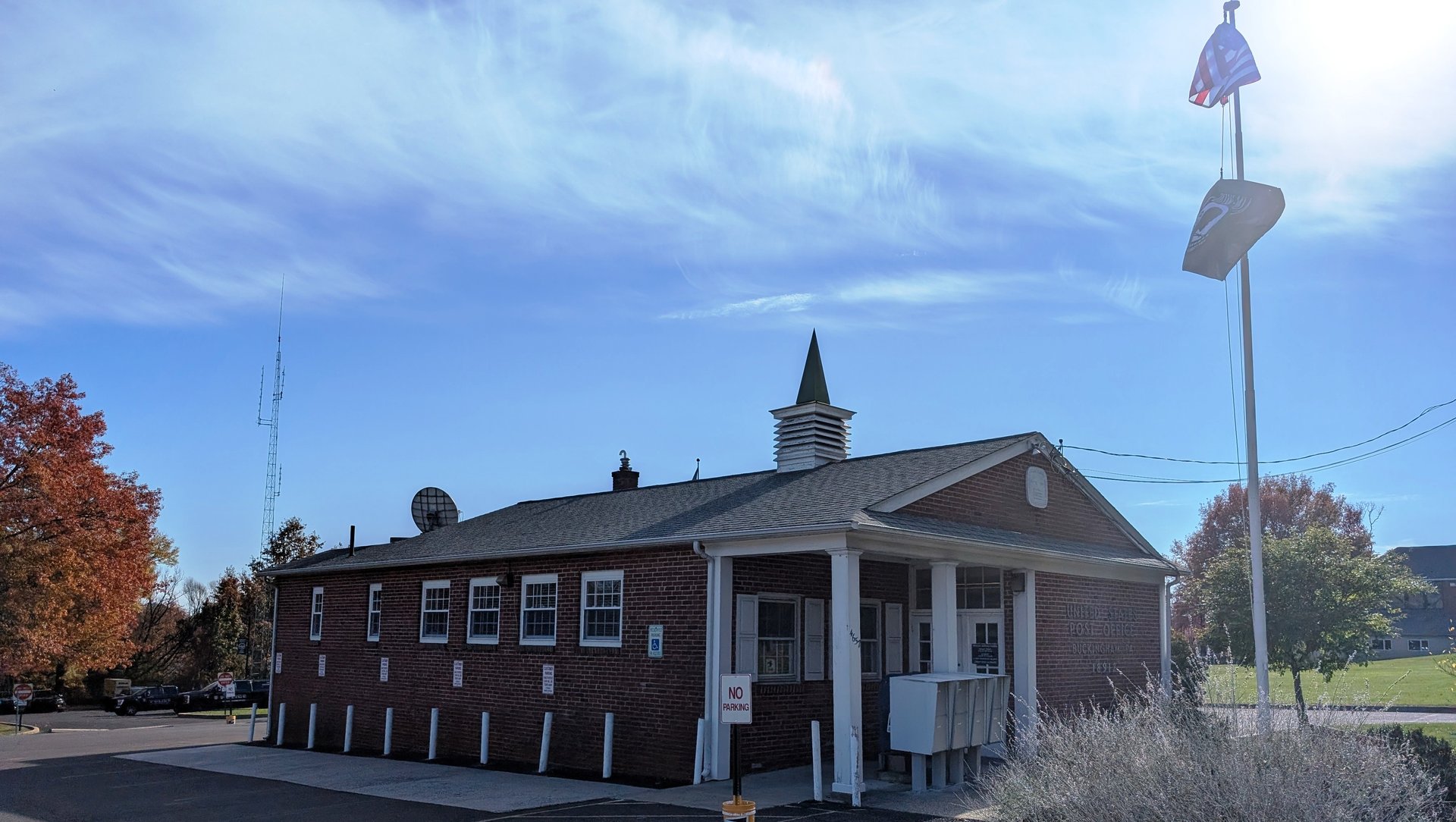 Buckingham post office, a brick building with a white cupola, on a sunny fall day
