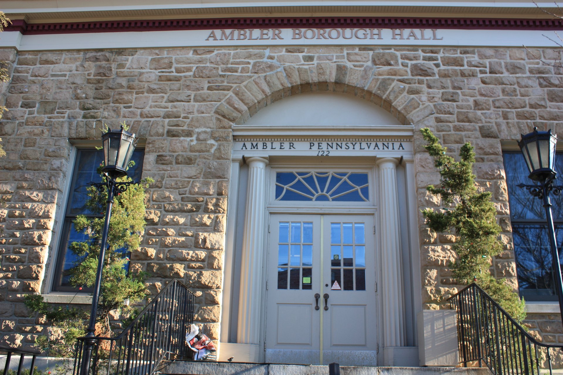 Entrance of Ambler Borough Hall, a stone building with an arched doorway