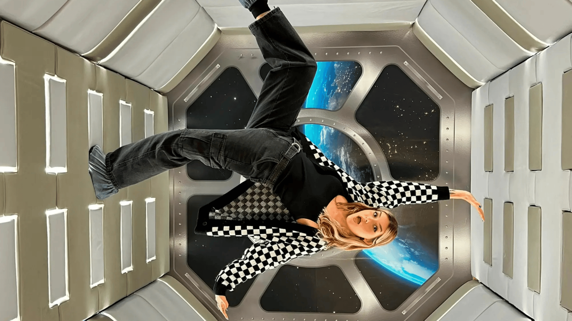 The Edit Real Estate Miami guide featuring interactive space-themed art installation with woman in checkered outfit floating in futuristic chamber