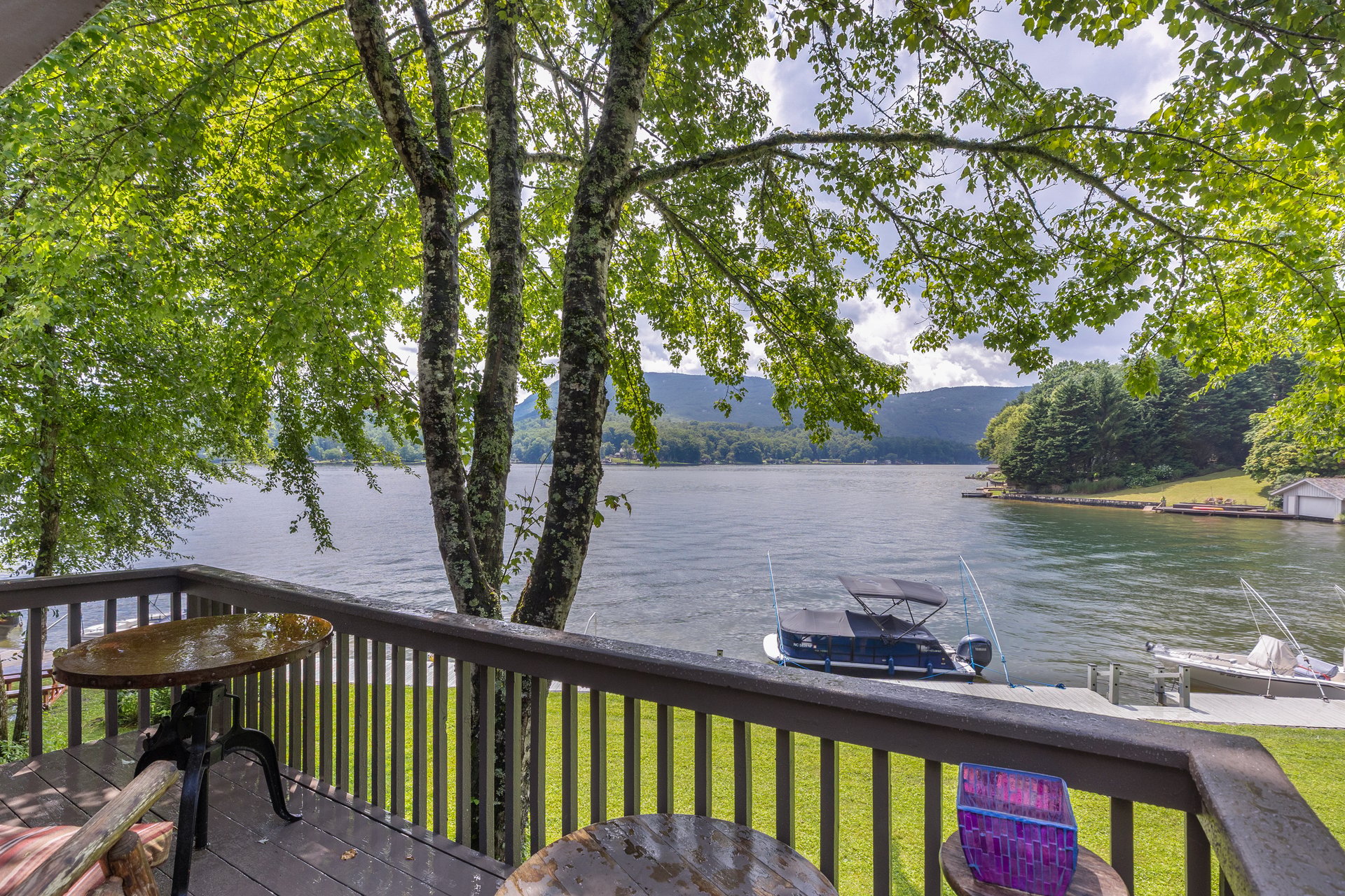 Deck view of Lake Toxaway with boats at the dock from 82 Innsbrook Drive, Lake Toxaway NC