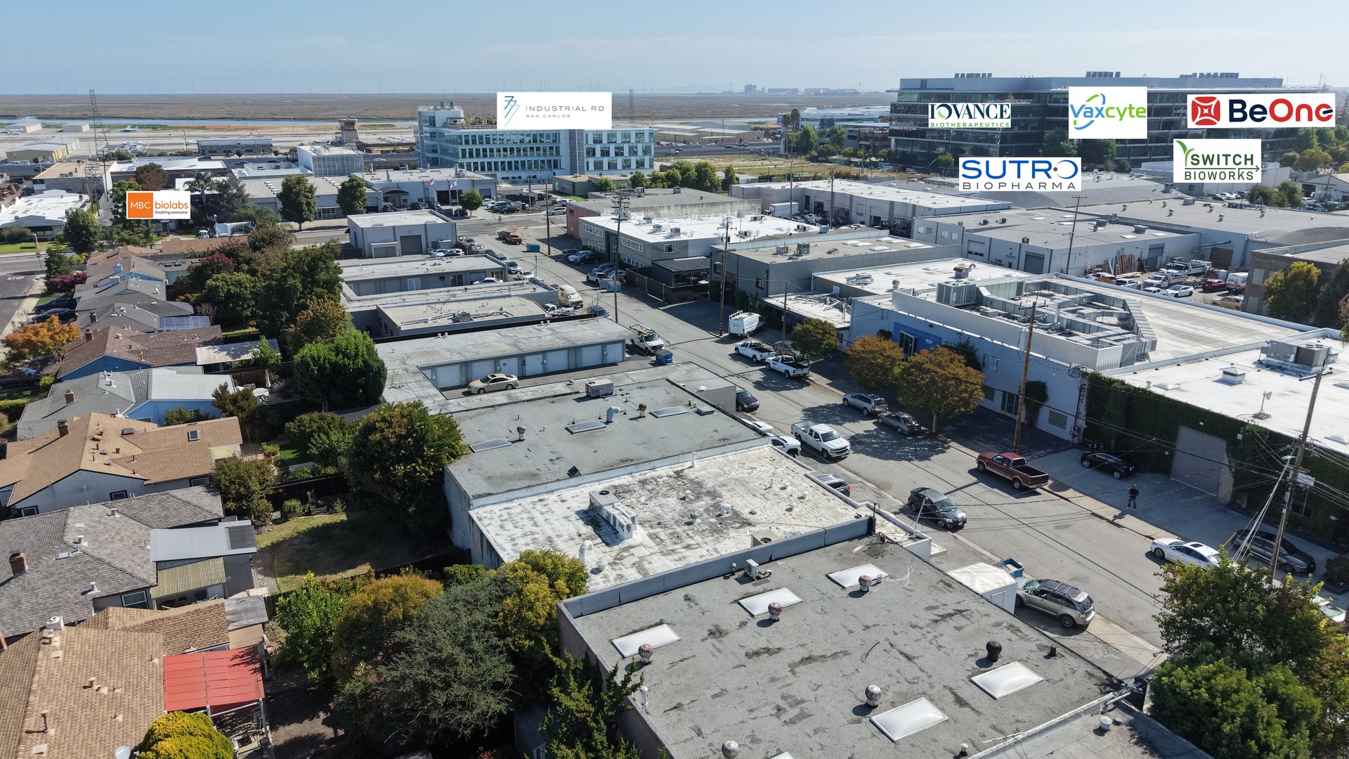Aerial view of San Carlos industrial buildings and streets, with biotech company labels.