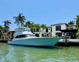 Large sportsfishing yacht docked at an Eastern Shores estate on the Williams Island waterway demonstrating deep-water frontage and high vertical clearance for major vessels