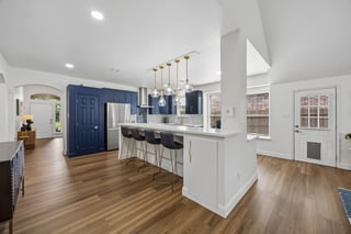 Updated kitchen with navy cabinetry and quartz countertops at 9217 Inverness in Rowlett, TX