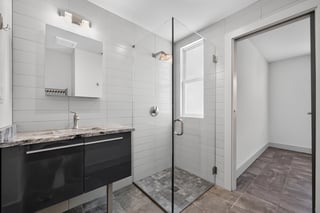 Ensuite bathroom with granite vanity, glass walk in shower and full height white tile at 2116 S. Beechwood Street in West Passyunk, South Philadelphia