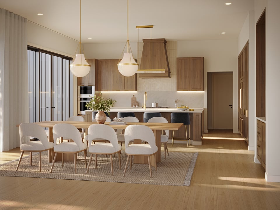 Open-plan kitchen and dining room with warm wood cabinetry and a long table beneath pendant lights.
