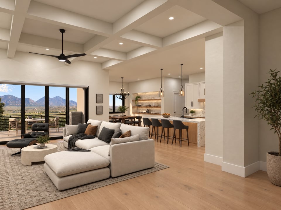Open-plan living room with a white sectional, kitchen island, and mountain views through sliding glass doors.