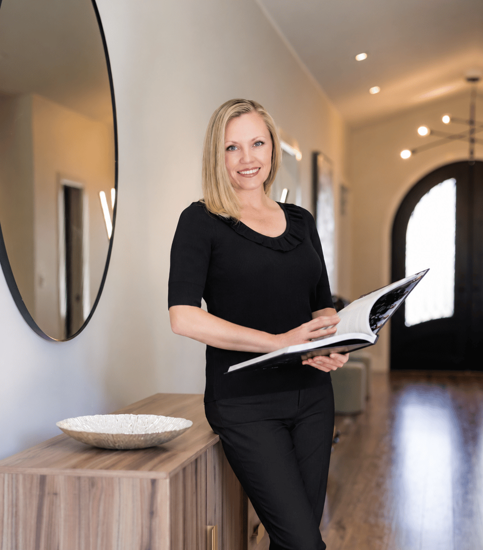 Jackie Purvis holding an open brochure in a bright, modern interior.