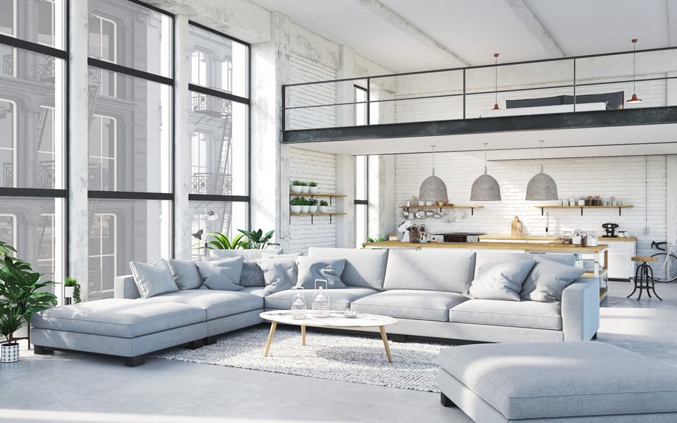 A loft apartment with a modern living room, kitchen area, several scattered houseplants, and floor-to-ceiling windows in Hudson County