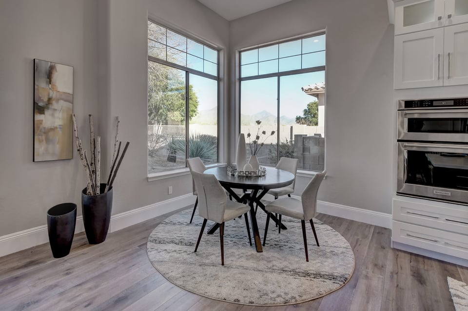Bright Scottsdale home dining room with large windows and modern furnishings