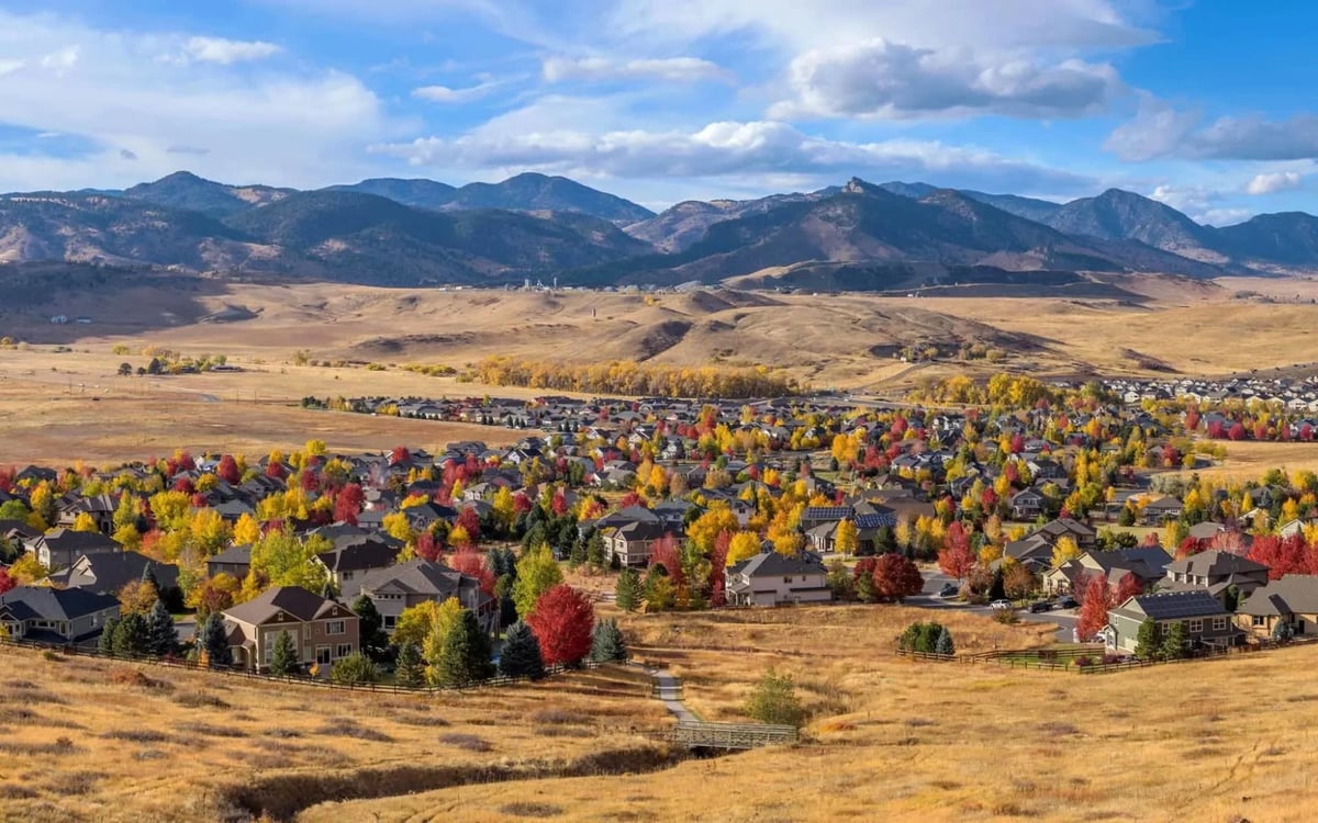 Arvada homes in fall at the edge of the foothills, with an open space trail in front