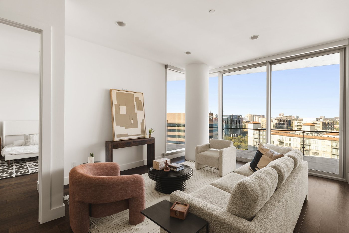Living room of Residence 1805 at Bleu Ciel with floor-to-ceiling windows and city views