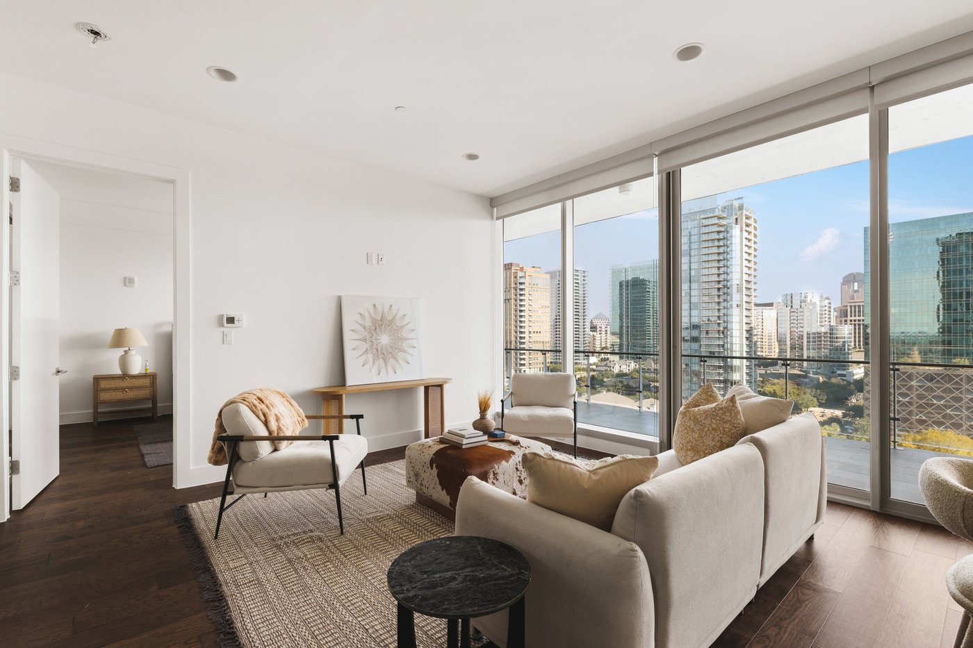 Living room of Residence 1507 at Bleu Ciel with floor-to-ceiling windows and Uptown Dallas skyline views
