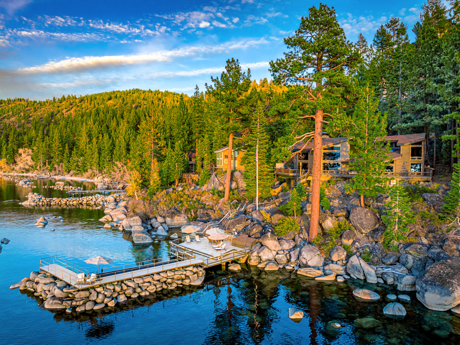 Aerial view of a Lake Tahoe lakefront home with a private pier