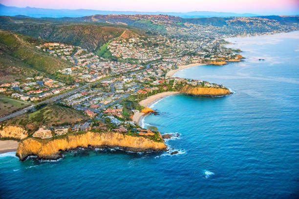 Aerial view comparing Newport Beach and Laguna Beach coastlines in Orange County, California, featuring luxury waterfront homes and sandy beaches