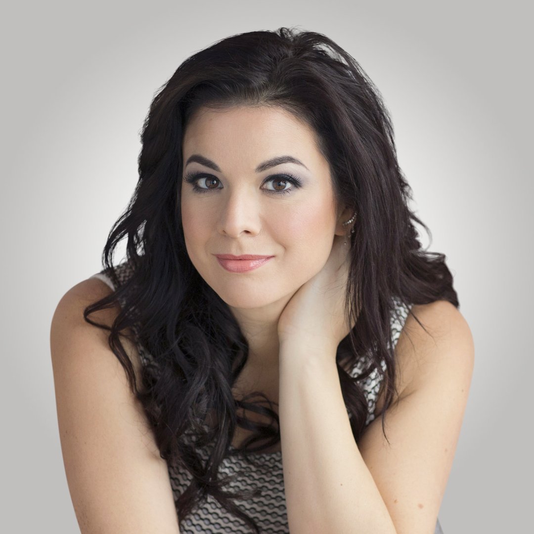 Sara Gaggi with long dark hair, resting her chin on one hand.