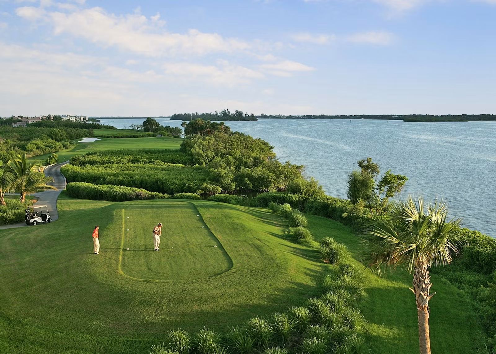 Golfer teeing off under open sky at Grand Harbor Golf and Beach Club, Vero Beach, Florida