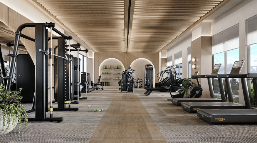 Modern fitness room with strength machines and treadmills beneath a wood-slat ceiling.