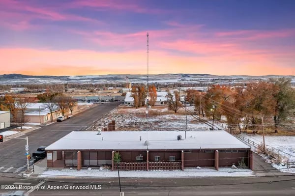 Craig, Colorado, at sunset, with snow-dusted streets and distant hills.