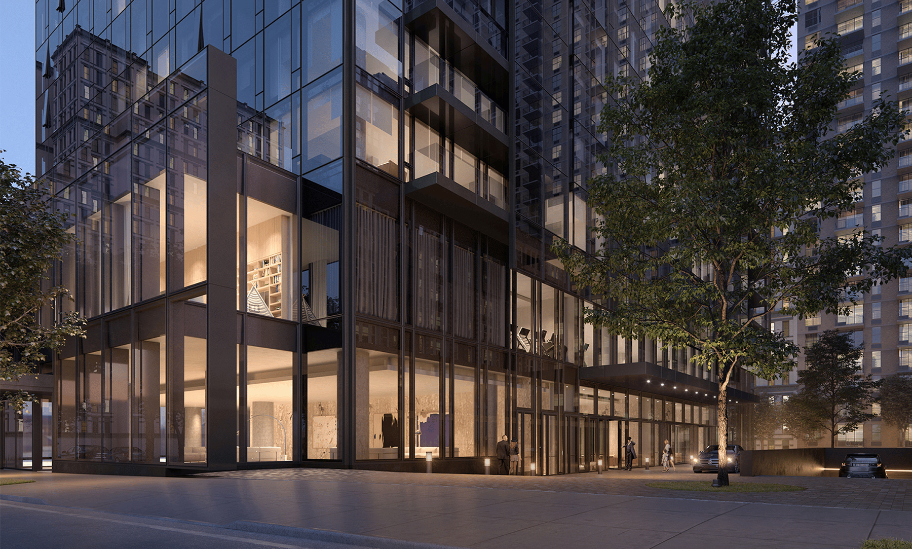 Glass residential tower at dusk with warmly lit interiors and a landscaped street-level entrance.