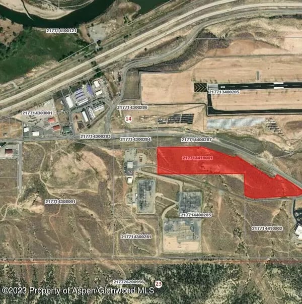 Aerial parcel map with one tract of land highlighted in red.