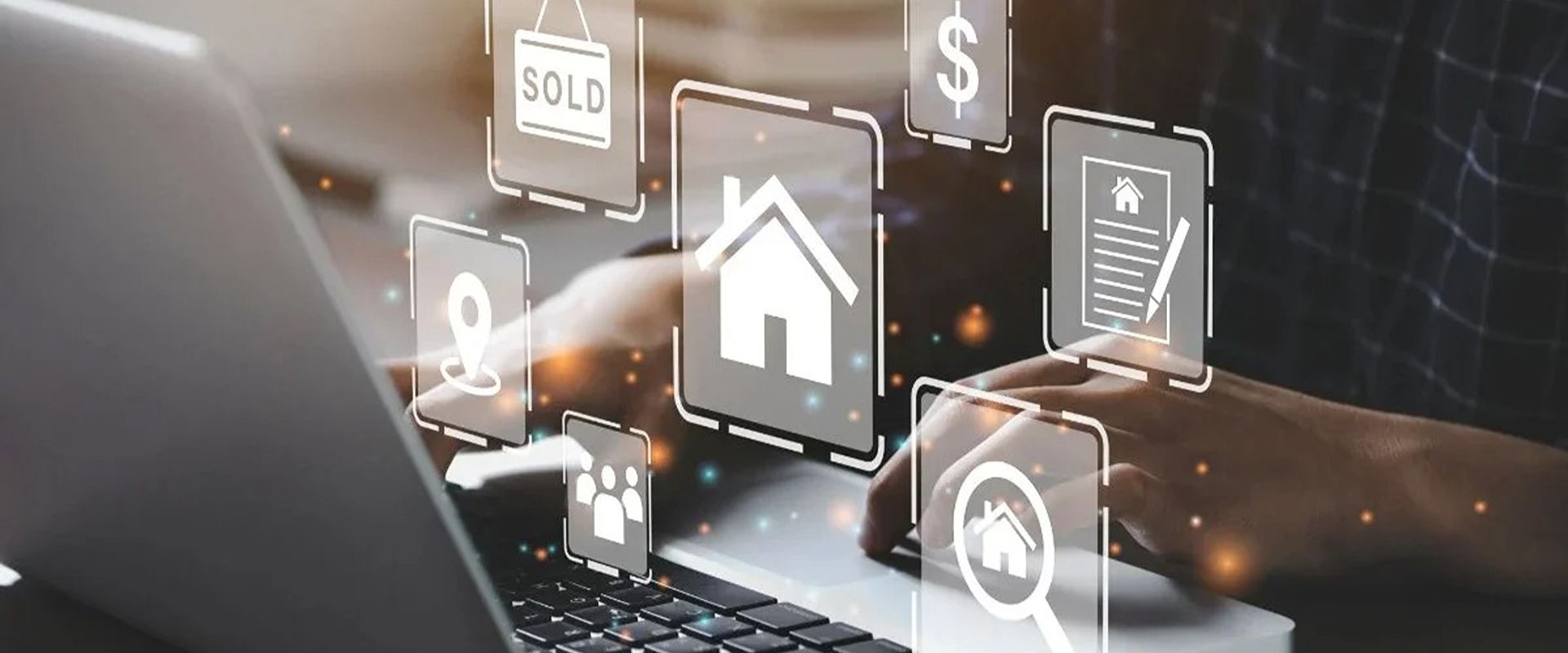 Hands use a laptop beneath real estate icons, including a house, sold sign, and dollar symbol.