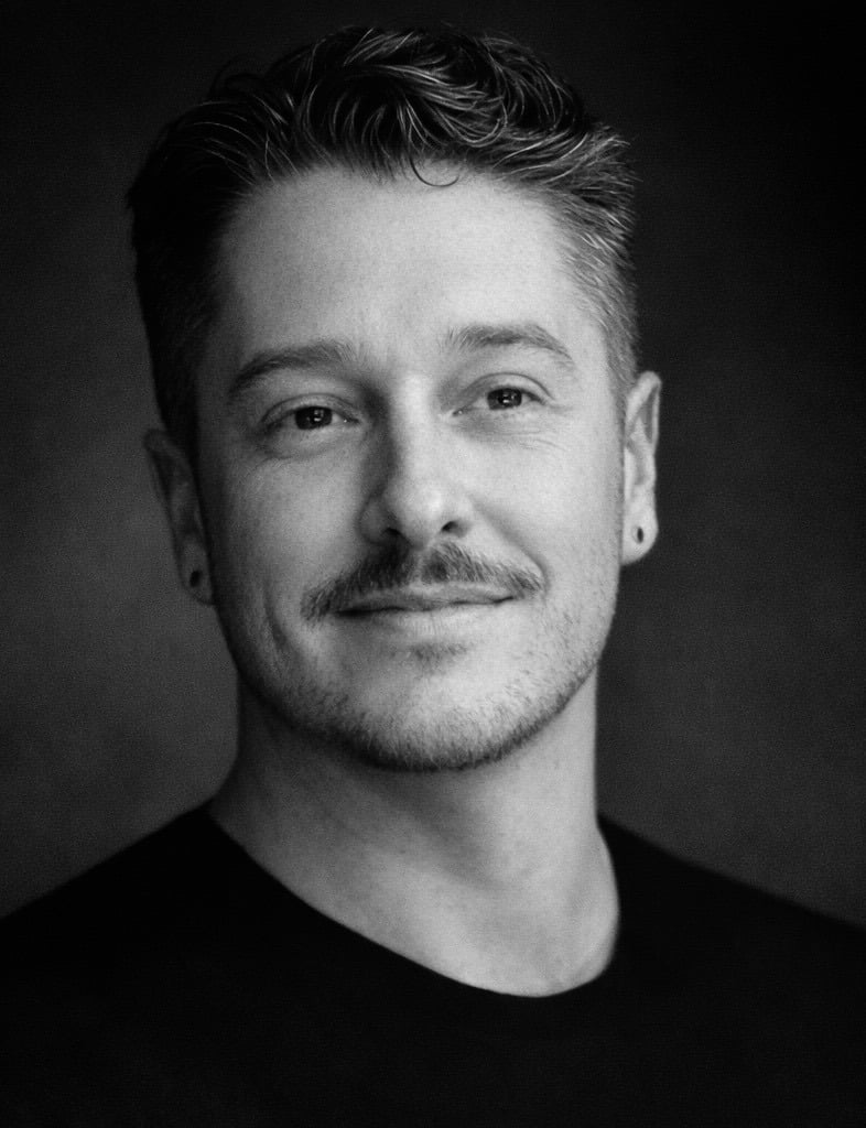 Black and white portrait of a Charlotte real estate agent wearing a dark crewneck shirt