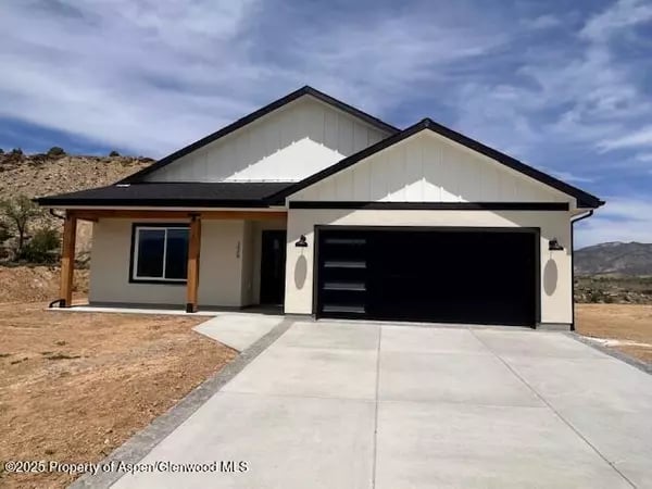 Modern single-story home with a wide driveway, covered porch, and attached two-car garage.