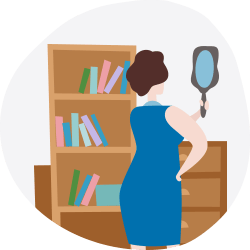 Woman holding a hand mirror beside a bookshelf and drawers.