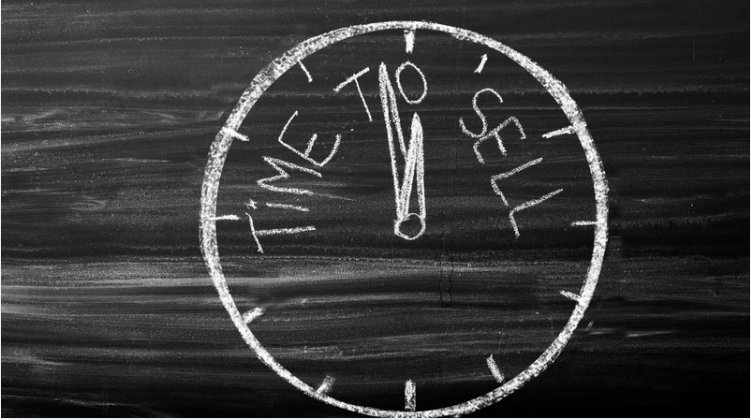Chalk clock marked “TIME” and “SELL.”