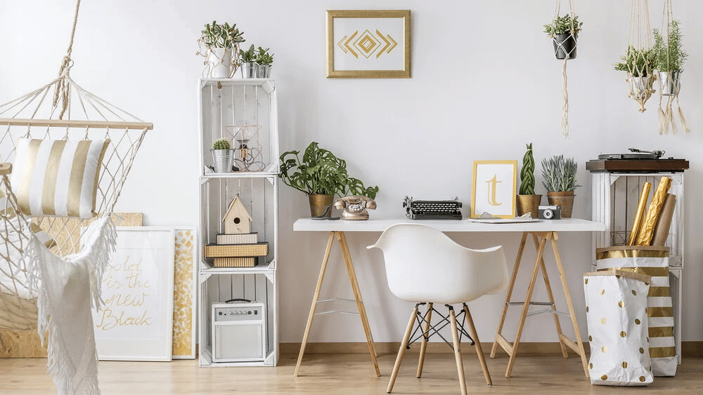 Staged home office with a white desk, molded chair, hanging chair, and leafy plants.