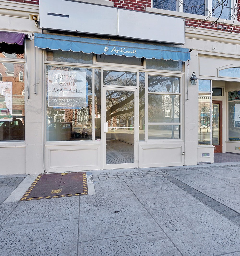 Vacant retail storefront with an April Cornell awning and a retail space available sign.