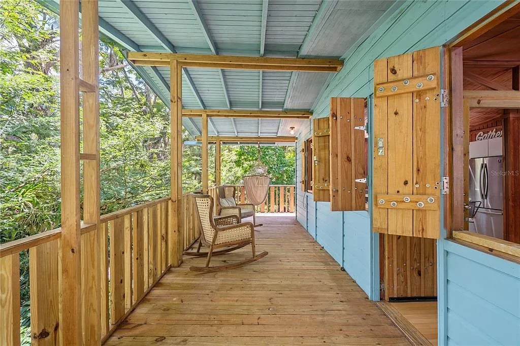 Covered wooden porch with rocking chairs