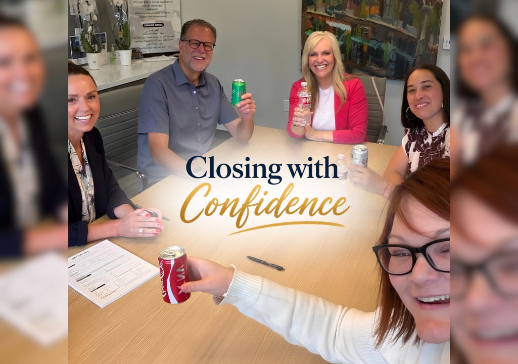 Sharla Ellis celebrating with homebuyers, their Realtor, and title partners at a successful home closing, highlighting the importance of teamwork and a confident mortgage experience.