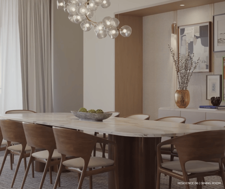 Dining room with a marble table, sculptural chairs, and a multi-globe chandelier.