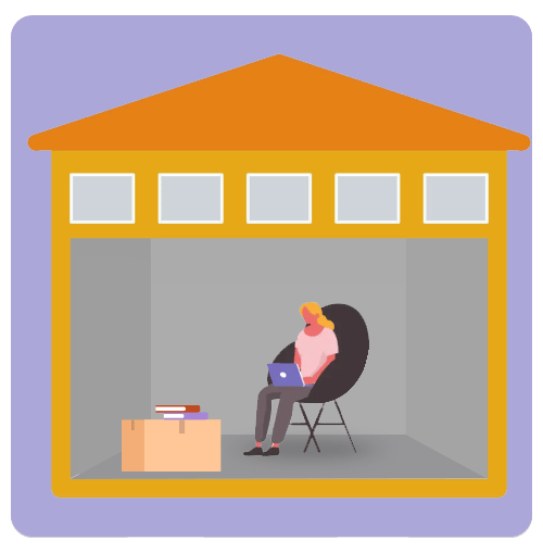 Open storage unit with a woman using a laptop beside a cardboard box.