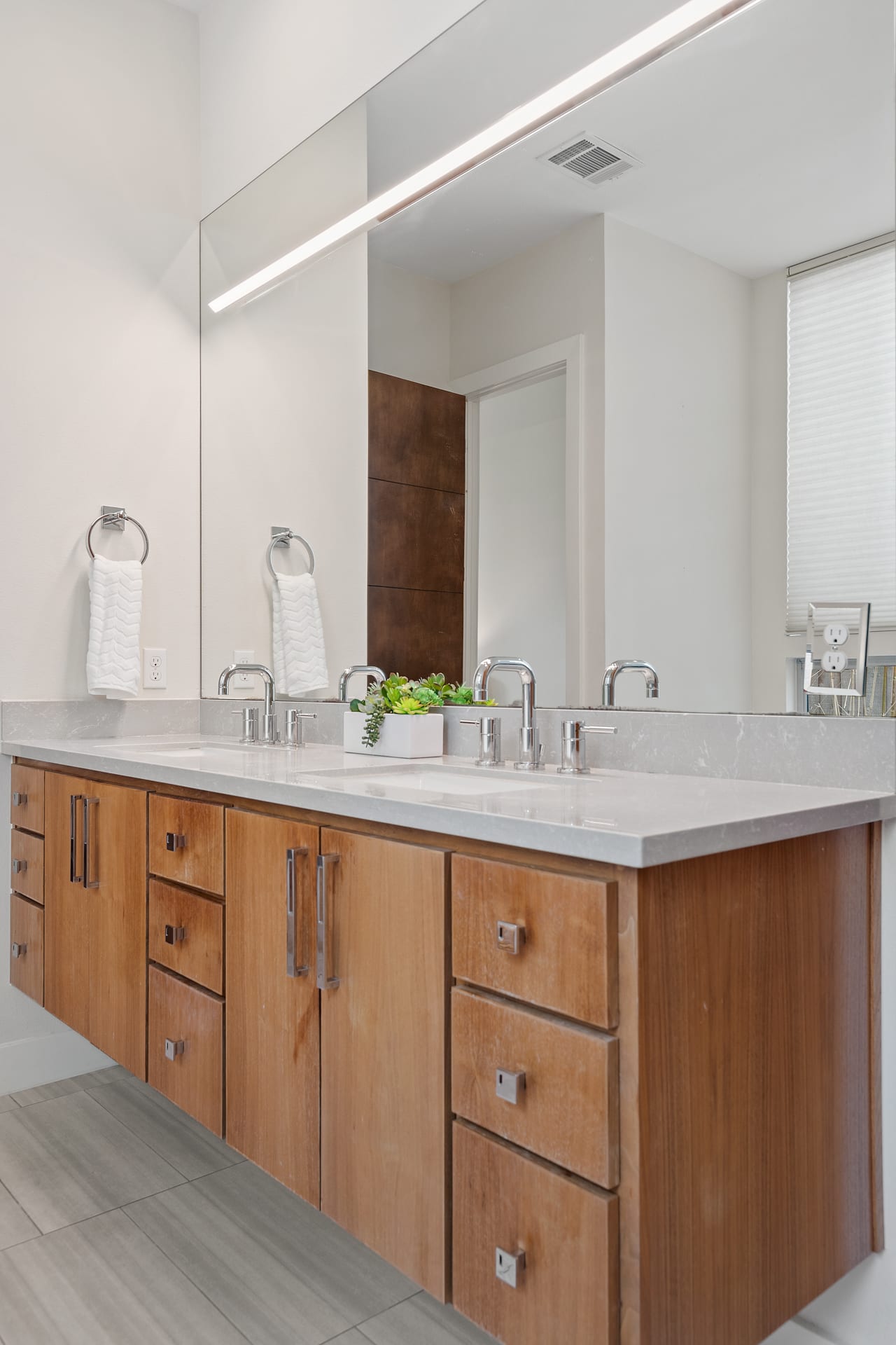 Bathroom wood vanity and mirror at 34 Margranita Crescent, Tarrytown, Austin, TX.
