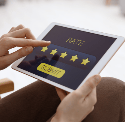 Hands tap a five-star rating on a tablet.