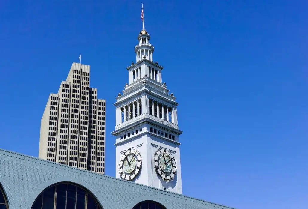 Close-up architectural detail of the Ferry Building's iconic clock tower with its ornate Spanish-inspired design