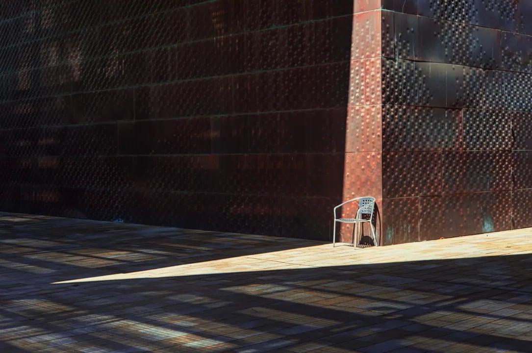 Close-up detail of the museum's perforated copper facade showing the interplay of light and shadow