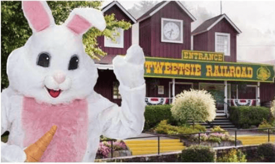 Easter Bunny waves in front of the Tweetsie Railroad entrance.
