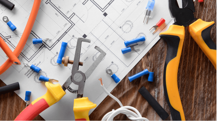 Electrical tools and wire connectors scattered across a building floor plan.