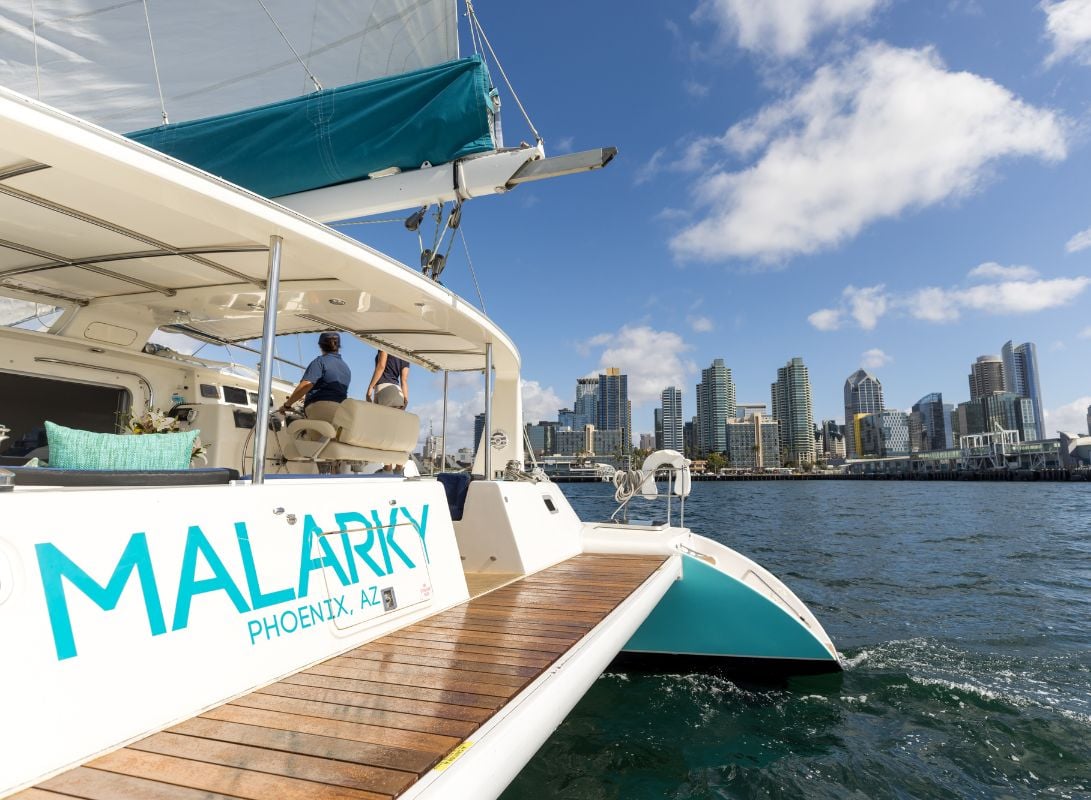 Malarky Charters luxury catamaran sailing in San Diego Bay with downtown skyline in the background