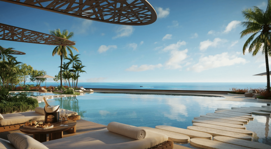 Rooftop pool terrace with ocean views, palm trees, and lounge chairs.