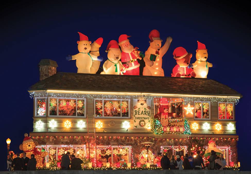Balboa Island waterfront homes decorated with Christmas lights reflecting on Newport Harbor
