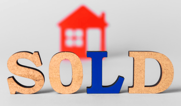 SOLD letters with a red house silhouette behind them.