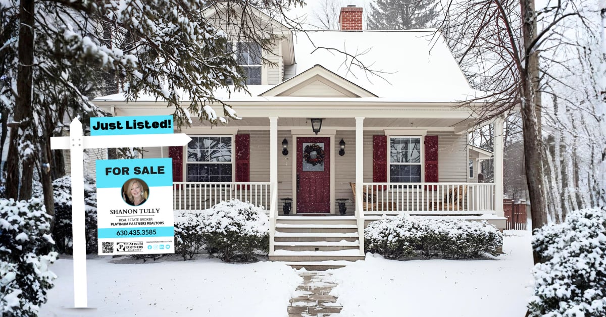 Snowy front exterior of a home with a &ldquo;Just Listed&rdquo; Shanon Tully for sale sign, illustrating what a Downers Grove home listed in winter can look like.