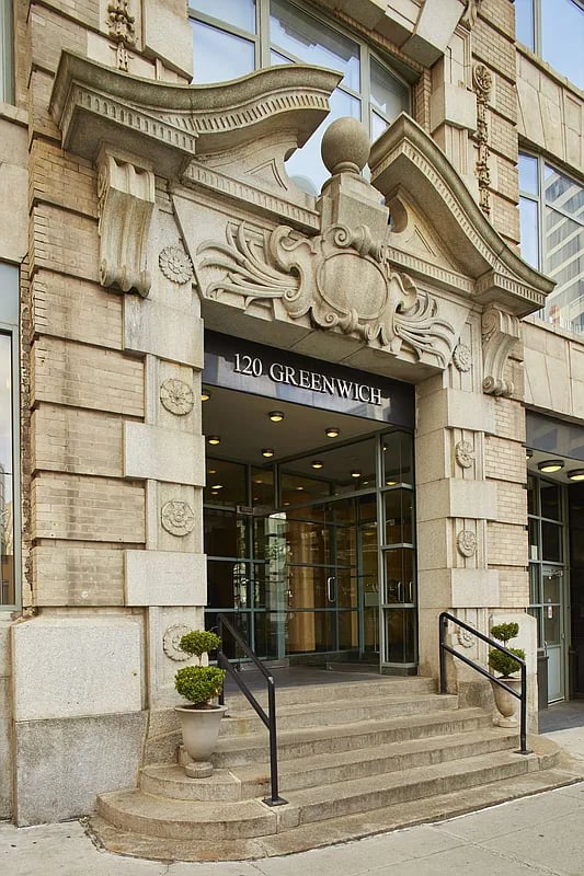 120 Greenwich Street entrance with ornate carved stonework and broad steps.