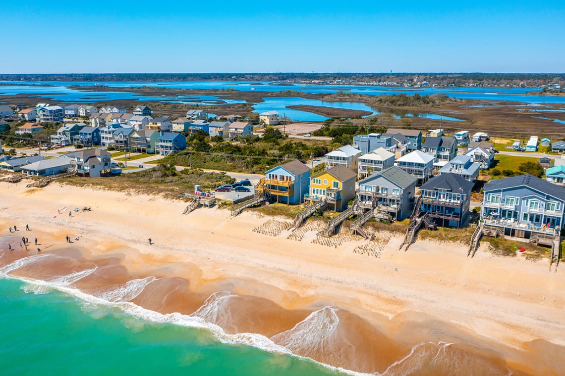 Aerial view of North Topsail Beach with oceanfront homes, sandy shore, and marsh waterways.
