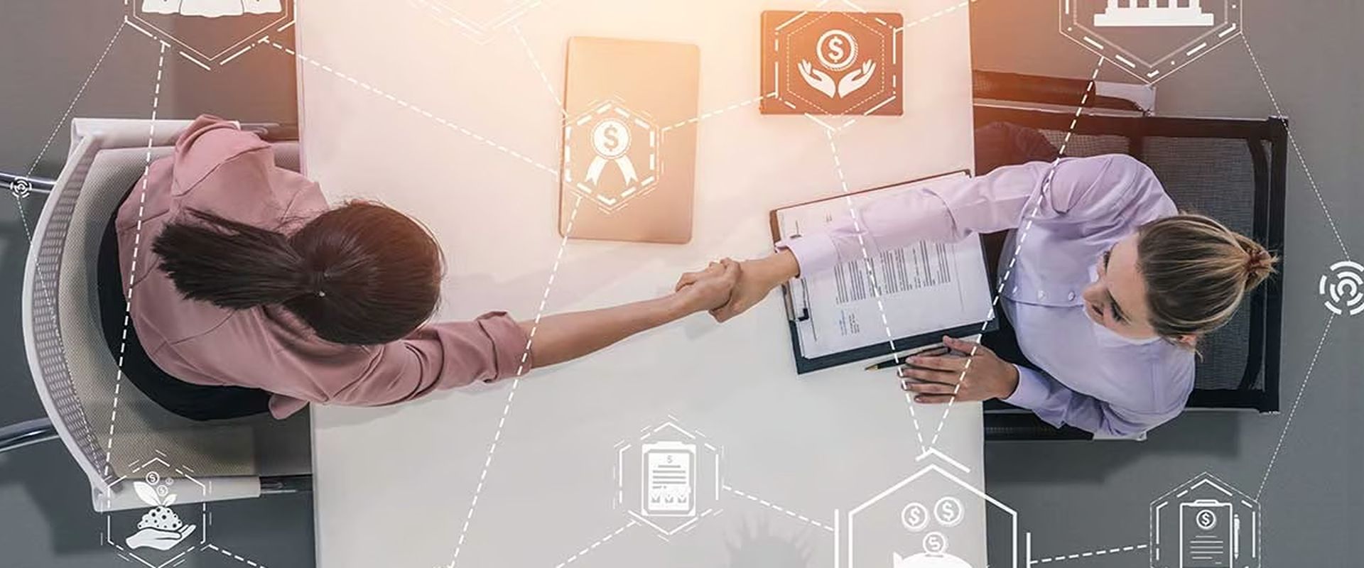 Two women shake hands across a desk beside a clipboard, with real estate and finance icons overlaid.